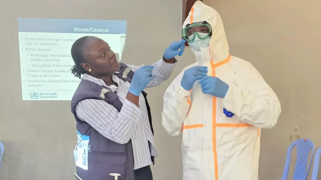 Health workers wearing protective equipment prepare an Ebola infection prevention area in the Democratic Republic of the Congo.