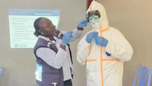 Health workers wearing protective equipment prepare an Ebola infection prevention area in the Democratic Republic of the Congo.