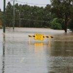A flooded road illustrating the dangers of driving through rising water