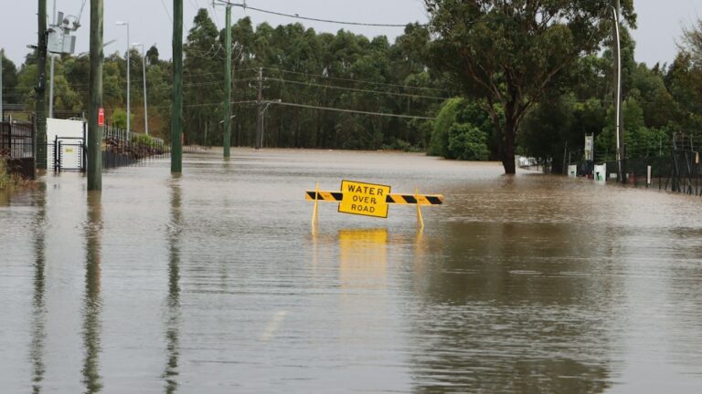 A flooded road illustrating the dangers of driving through rising water