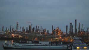 Illuminated oil refinery complex at dusk, used to illustrate the Moscow drone attack