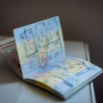 Illustrative image of an open passport with travel stamps, representing international passport processing.