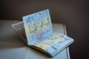 Illustrative image of an open passport with travel stamps, representing international passport processing.