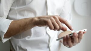 A person using a smartphone, illustrating mobile-message security