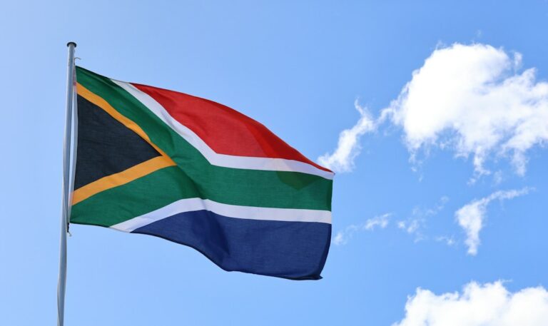 South African national flag flying against the sky
