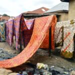 Colourful adire fabrics hanging on a line in Abeokuta, Ogun State