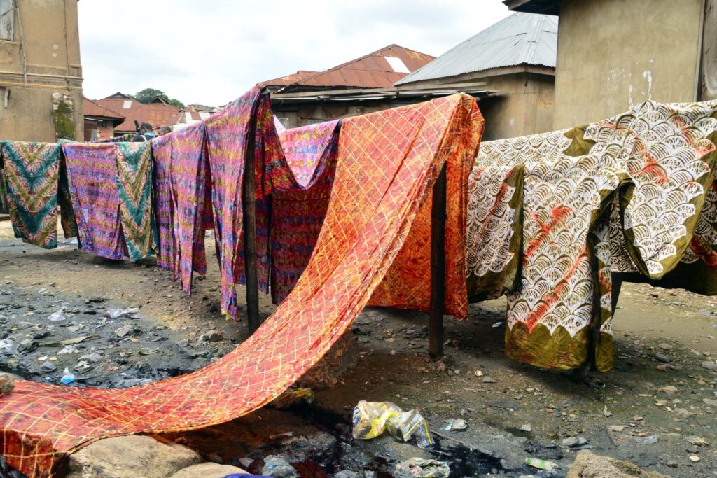 Archive photograph of patterned Adire fabrics hanging on lines in Abeokuta, Ogun State, in 2018