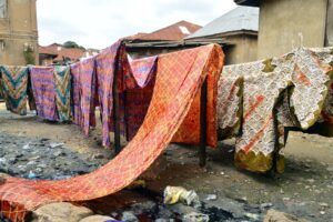 Archive photograph of patterned Adire fabrics hanging on lines in Abeokuta, Ogun State, in 2018