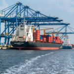 Cargo ship beside cranes at a container port