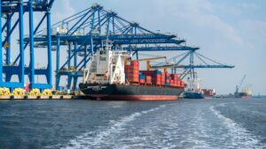 Cargo ship beside cranes at a container port