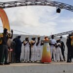 Dakar 2026 flame relay participants around a ceremonial cauldron in Diamniadio on 26 September 2026