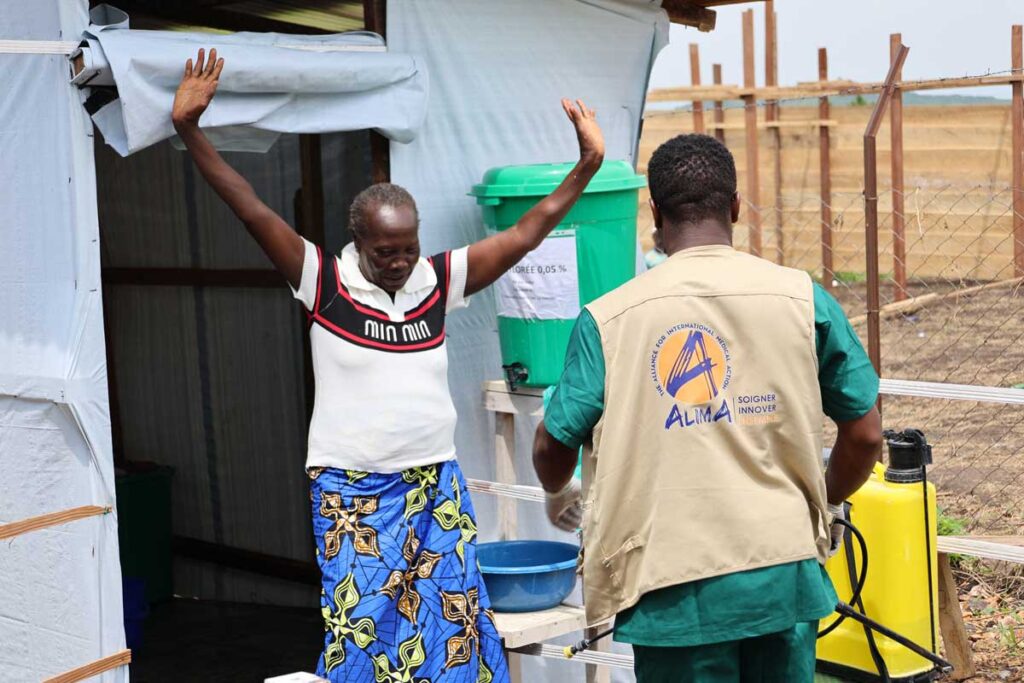 An Ebola survivor leaves the disinfection area at the Rwampara treatment centre in eastern Congo