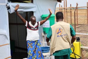An Ebola survivor leaves the disinfection area at the Rwampara treatment centre in eastern Congo