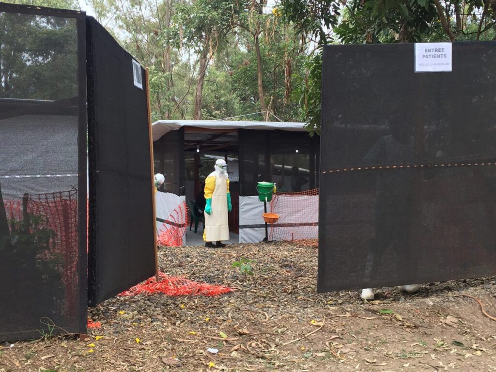 A healthcare worker in protective clothing waits at an Ebola transit centre in Bukavu, Democratic Republic of Congo