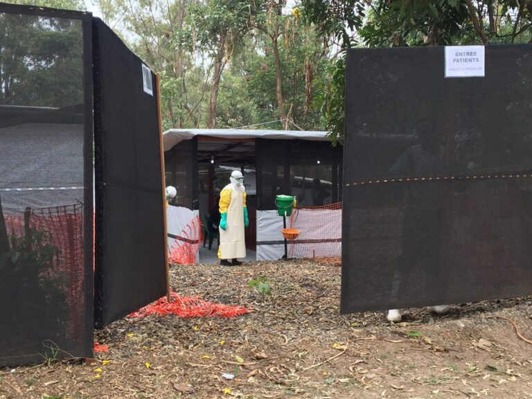 A healthcare worker in protective clothing waits at an Ebola transit centre in Bukavu, Democratic Republic of Congo
