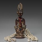 Yoruba-style ere ibeji memorial figure with beads, metal arm ornaments and cowrie shells, Cleveland Museum of Art, 2016.9.