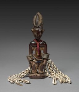 Yoruba-style ere ibeji memorial figure with beads, metal arm ornaments and cowrie shells, Cleveland Museum of Art, 2016.9.