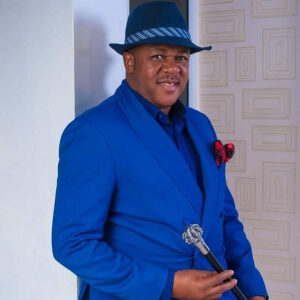 Nollywood actor Francis Duru wearing a blue suit and hat