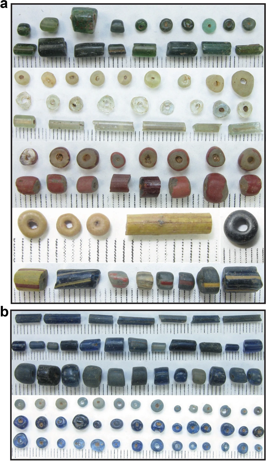 Glass beads of varying colours and shapes from Ile-Ife, including cylindrical and perforated beads.