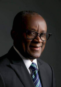 John Enoh in a suit and glasses, photographed on 17 August 2023. Archive portrait.