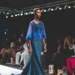Model in a blue embellished gown at Lagos Fashion and Design Week on 29 October 2015; archival photograph.