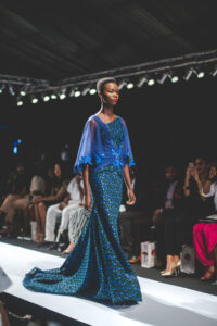 Model in a blue embellished gown at Lagos Fashion and Design Week on 29 October 2015; archival photograph.