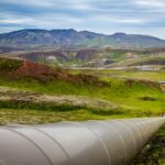 Natural gas pipeline running across a green landscape