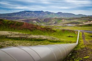 Natural gas pipeline running across a green landscape