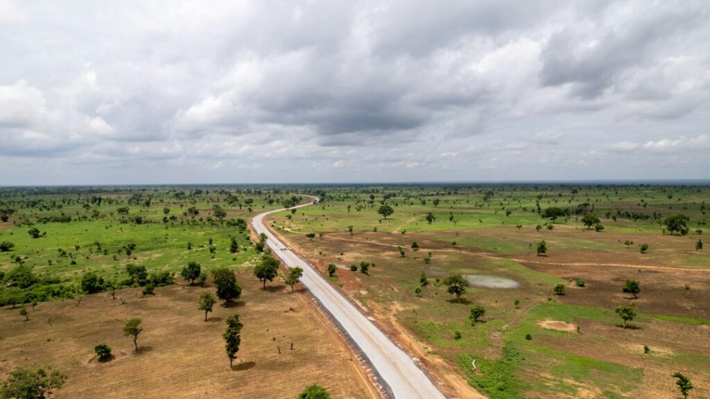 Aerial view of a Nigerian highway through open countryside