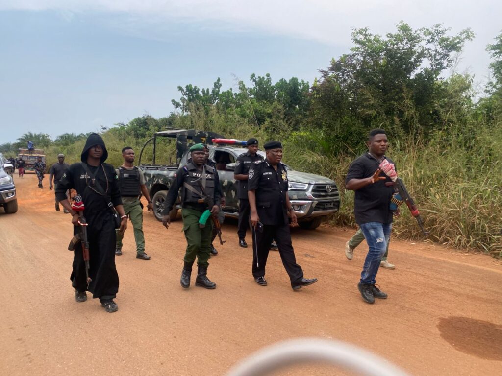 Nigerian police officers conducting a security patrol on a rural road in Imo State