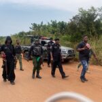 Nigerian police officers conducting a security patrol on a rural road in Imo State