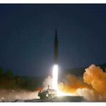 A North Korean ballistic missile launching from a mobile platform at night