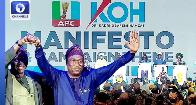 Obafemi Hamzat, right, waves beside Babajide Sanwo-Olu in a Channels Television image of the Lagos manifesto launch.