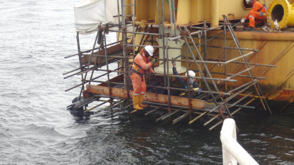 Archive photograph of Windfall Engineering personnel working on an offshore oil facility in Nigeria, dated 2012; illustrative industry photograph.