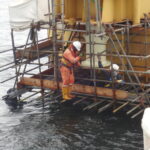 Archive photograph of Windfall Engineering personnel working on an offshore oil facility in Nigeria, dated 2012; illustrative industry photograph.