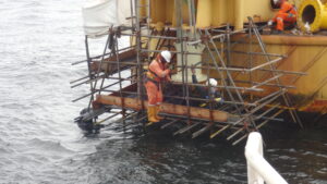 Archive photograph of Windfall Engineering personnel working on an offshore oil facility in Nigeria, dated 2012; illustrative industry photograph.