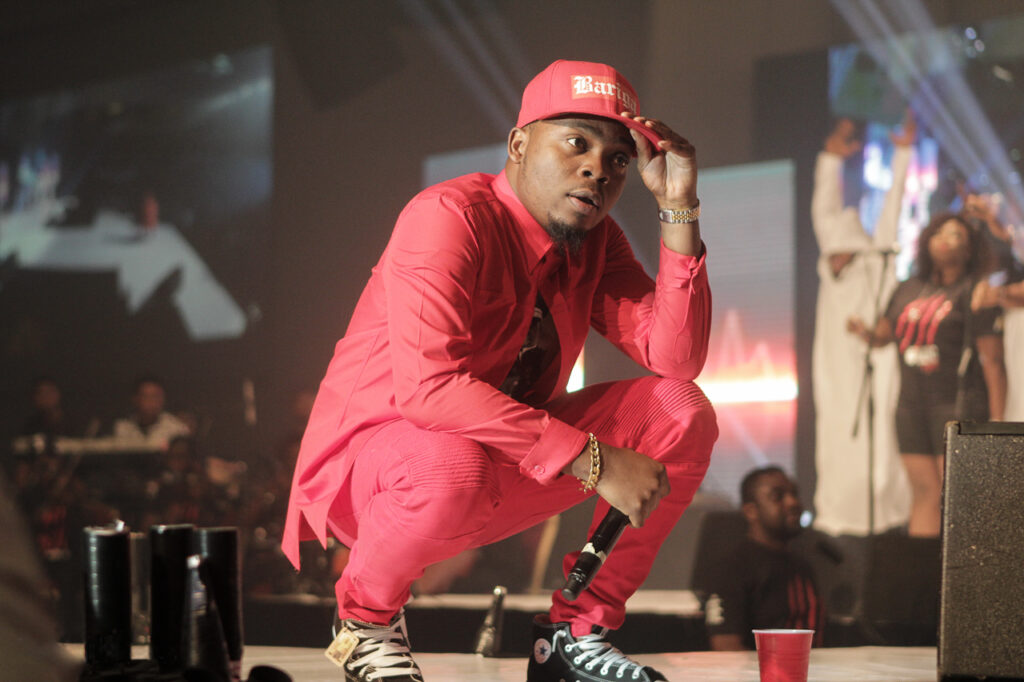 Olamide holding a microphone at Olamide Live In Concert on 28 December 2014.