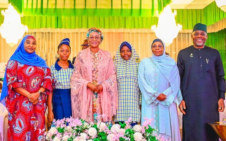 First Lady Oluremi Tinubu speaking with schoolgirls at the Flow with Confidence 2.0 launch in Abuja