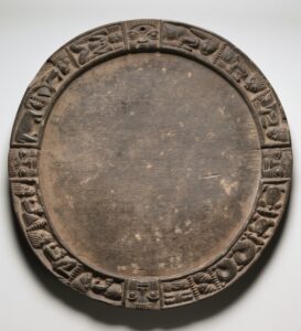 Wooden Yoruba divination tray with four carved faces and animal motifs around its rim, Cleveland Museum of Art 1993.235.