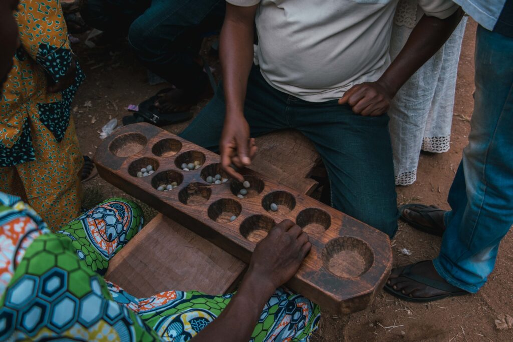 Men gathered around an ayo board in Nigeria in an archive photograph taken on 2 November 2018.