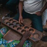 Men gathered around an ayo board in Nigeria in an archive photograph taken on 2 November 2018.