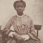 Sarah Forbes Bonetta, born Àìná, seated in a Victorian dress in a portrait by William Bambridge