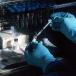Scientist preparing a vaccine under a sterile laboratory hood