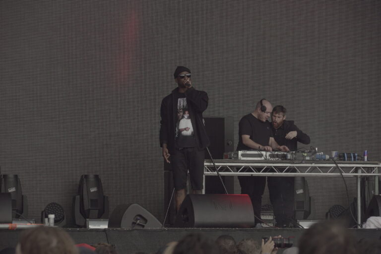 Skepta holding a microphone on stage at Field Day in London on 11 June 2016