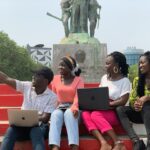University students using laptops together during a study session