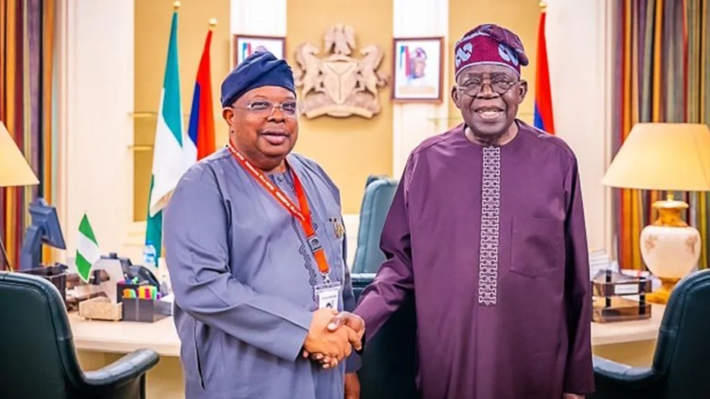 Joseph Olasunkanmi Tegbe shaking hands with President Bola Tinubu in an archive photograph