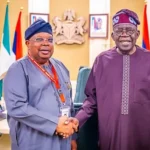 Joseph Olasunkanmi Tegbe shaking hands with President Bola Tinubu in an archive photograph