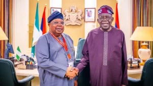 Joseph Olasunkanmi Tegbe shaking hands with President Bola Tinubu in an archive photograph