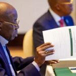 President Bola Tinubu holding a document during a meeting in an archive photograph